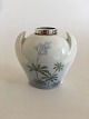 Bing and 
Grondahl Art 
Nouveau vase 
with silver 
top. Measures 
11cm and is in 
good condition.