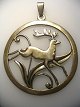 Locket in 
silver with 
leaping deer, 
Denmark, 
stamped .: CKH. 
830 s. With 
pendant. Dia .: 
4.3 cm.