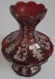 Bohemian vase, 
19th century. 
8-side faceted, 
in red glass 
with gold 
decoration and 
enamel paint 
...