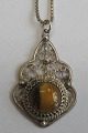 Pendant in 
silver filigree 
work with 
amber, 20th 
century. With 
sterling silver 
chain, stamped. 
H ...