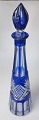 Bohemian clear 
carafe with 
blue overlay, 
20th century. 
With cuts 
through the 
blue. H .: 44 
cm.