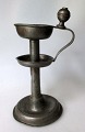 Antique oil 
lamp in tin, 
Baroque, 
Germany, 18th 
century. Round 
foot with 
molded strain. 
Handle. ...