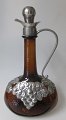 Brown jug with 
tin mounting, 
1930, Denmark. 
With stopper. 
Decorations as 
vine leaves. H 
.: 26 cm.