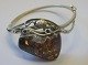 Silver bracelet 
with polished 
piece of amber, 
20th century. 
Denmark. Dia .: 
5.5 cm. 
Stamped.