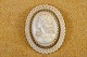 Cameo lady head 
molded in in 
bakelite, 
french ivery, 
with decorative 
edge of brass. 
Size .: 5.5 ...
