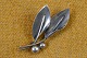 Brooch of 
silver shaped 
as small twig 
with 2 knobs 
and 2 curved 
leaves. Stamped 
Sterling COF 
...