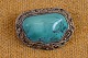 Brooch with 
large turquoise 
mounted in the 
decorative 
frame. Stamped 
925 EPF (Erik 
Poul Fenster 
...