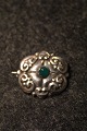 Old Art Nouveau 
brooch in 
silver with 
small green 
stone. Measure: 
4x3,5cm.