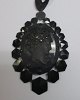 Pendant 
necklace, 
painted iron, 
with Came the 
woman in 
profile, 1880. 
Came crafted in 
hematite. ...