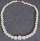 Necklace of 
ivory, lathed, 
about 1900 with 
hole 
decoration. L. 
42 cm. With 
silver close.