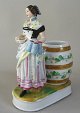 German 
porcelain 
figure, 
about 1880, in 
shape of a 
waitress in 
dress with 
bread and beer 
mug. ...