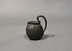 Small jug with 
handle in disco 
metal by Just 
Andersen.
H - 13 cm, W - 
10 cm and D - 6 
cm.