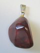 Polished amber 
piece, Denmark. 
With silver 
eye. Length: 
4.5 cm.