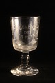 Old French 
souvenir wine 
glass with 
engraved 
writing and 
decorations. 
"Souvenir de la 
feté" ...