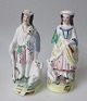 Pair of 
Staffordshire 
fajance figures 
of man and 
woman with 
dogs, approx. 
1840. England. 
...