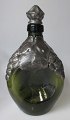 Green bottle 
with pewter 
decorations, 
1920 - 1930, 
Denmark. 
Height: 23 cm.
Perfect 
condition!