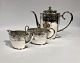 Coffee set of 
coffe jug, 
sugar bowl and 
cream jug with 
chasings. The 
set is of 
hallmarked 
silver ...