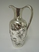 P. Hertz. 
Silver (830). 
Water pitcher 
with flower 
motif. Height 
26 cm. Produced 
1900.