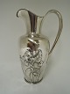 KOH. Silver 
(830). Water 
pitcher with 
flower motif. 
Height 26 cm. 
Produced 1908.