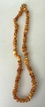 Amber chain, 
milk amber, 
polished 
pieces, 20th 
century. 
Denmark. 
Length: 48 cm.