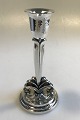 Evald Nielsen 
Sterling Silver 
One-light 
candlestick 
with chasesd 
foliate on 
stepped base H 
...