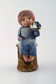 Lisa Larson for 
Gustavsberg. 
Rare stoneware 
figure. Girl 
with flowers.
Measures: 22,5 
cm x 12 ...