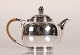 Cohr Silver - 
Denmark
Art Deco 
Teapot from 
1939 with cane 
handle
Made of silver 
830s and ...