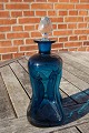 Cluck cluck 
decanter or 
cluck bottle of 
dark-blue glass 
with cork of 
clear glass, by 
Holmegaard ...