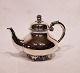 Tea pot of 
hallmarked 
silver 
decorated with 
grapes and on 
feet. The pot 
is in great 
vintage ...