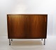 This cabinet 
with sliding 
doors in light 
mahogany is a 
characteristic 
example of 
Danish design 
...