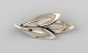 Danish 
modernist 
brooch in 
sterling silver 
in the form of 
leaves. 1960's.
In very good 
...