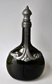 Green bottle 
with pewter 
mounting, art 
deco, 1930s, 
Denmark. 
Height: 27 cm.