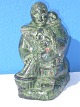 Figurine of 
soapstone, 
woman with 
children. 
Height 16 cm. 
Bredte 8 cm. X 
12 cm. Made in 
Canada.