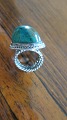 A ring made of 
silver with a 
beautiful green 
stone ,- a very 
beautiful and 
personable ring 
...
