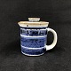 Height 12 cm.
Marked UH in 
handwriting and 
L. Hjorth.
The pitcher is 
decorated in 
blue, ...