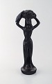 Scandinavian 
ceramist. 
Sculpture in 
black glazed 
ceramics. Woman 
carrying 
basket. ...