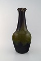 Daum Nancy, 
France. 
Colossal art 
deco vase in 
mouth-blown art 
glass in green 
and brown 
shades. ...