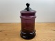 The purple 
glass pharmacy 
jar is 27 
centimeters 
high incl. the 
lid and 14 
centimeters ...
