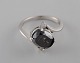 Large cocktail 
ring in 14 
carat white 
gold with oval 
facet cut black 
diamond of 
approx. 3.50 
ct. ...