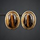 Earrings set 
with tiger-eye. 

A pair of 
earrings, made 
in 14k gold set 
with tiger-eye. 
2,6 x 2 ...
