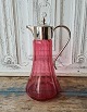 Beautiful wine 
jug in 
raspberry-
colored glass 
with 
silver-plated 
mounting. 
Height 26 cm.