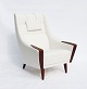 The armchair 
with a high 
back, 
beautifully 
upholstered in 
white fabric 
and elegantly 
resting on ...