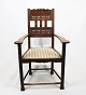 Antique 
armchair of oak 
and upholstered 
with striped 
upholstery from 
the 1930s. The 
chair is in ...