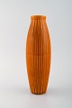 Bo fajans, 
Sweden. Vase in 
glazed ceramics 
with ribbed 
body. Beautiful 
glaze in dark 
orange ...