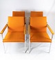 This set of 
four armchairs, 
made with 
orange wool 
fabric and 
chrome frame 
with oak 
armrests, is 
...