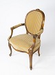 Rococo armchair 
of light wood 
and upholstered 
with light 
velvet fabric 
from the 1920s. 
The chair ...