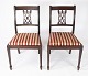 A pair of 
dining room 
chairs of 
mahogany and 
upholstered red 
fabric from the 
1960s. The 
chairs ...