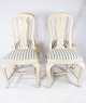 A set of four 
antique dining 
room chairs of 
white painted 
wood and 
upholstered 
with light ...