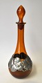 Danish brown 
liqueur bottle 
with pewter 
mounting, 
approx. 1930. 
With sopper. 
Pewter mounting 
in ...