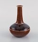 Kähler, HAK. 
Narrow neck 
vase in glazed 
ceramics. 
Geometric 
pattern on 
brown 
background. ...